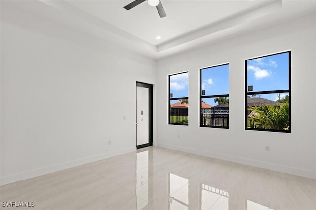 empty room featuring plenty of natural light, a ceiling fan, baseboards, light tile patterned flooring, and recessed lighting