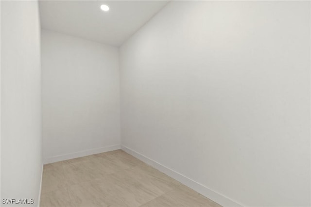 empty room with baseboards and recessed lighting
