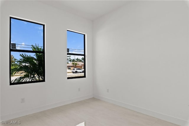 unfurnished room featuring baseboards