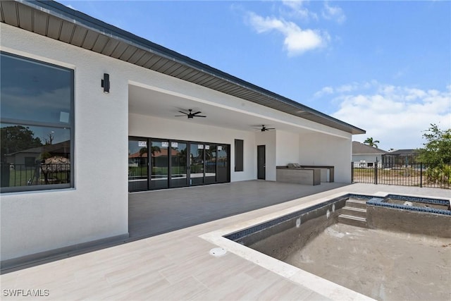 view of pool featuring ceiling fan, fence, an in-ground hot tub, and a patio area
