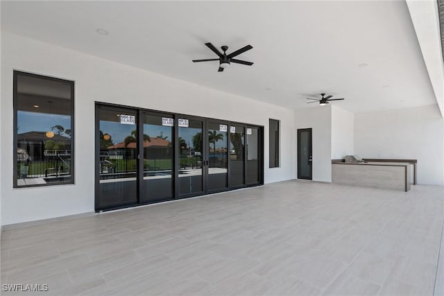 unfurnished living room with a ceiling fan