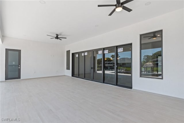 empty room featuring a ceiling fan and wood finished floors