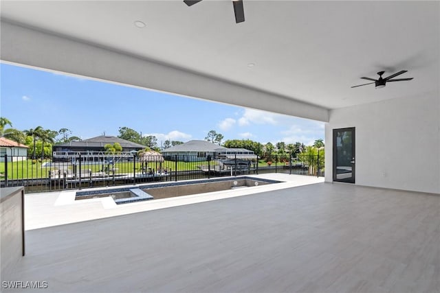 view of patio / terrace with fence, a residential view, and ceiling fan