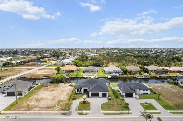 aerial view of residential area featuring a nearby body of water