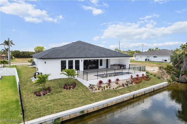 back of house with a water view, a shingled roof, stucco siding, and a patio