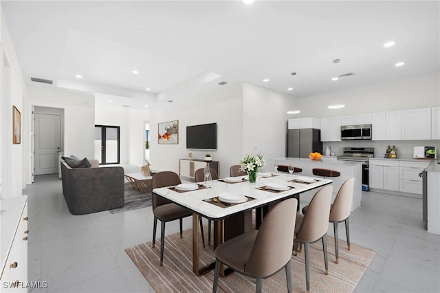 710 Eisenhower Blvd, Lehigh Acres, FL 33974 - dining area featuring light marble finish flooring and recessed lighting