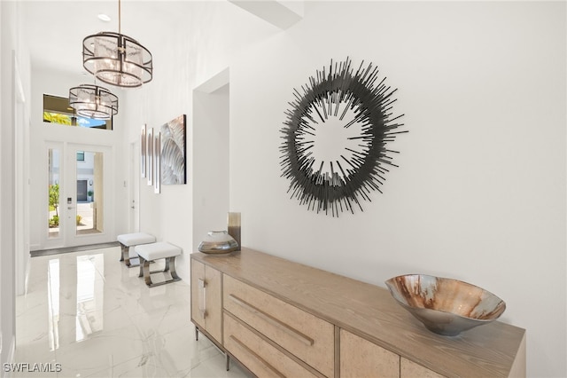 20321 Fair Oak Ln, Estero, FL 33928 - hallway featuring marble finish floor and a notable chandelier