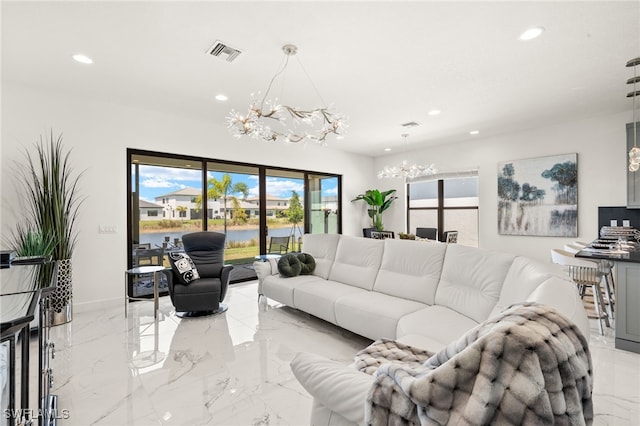 20321 Fair Oak Ln, Estero, FL 33928 - living room with recessed lighting, visible vents, marble finish floor, and an inviting chandelier