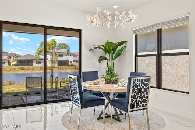 20321 Fair Oak Ln, Estero, FL 33928 - dining room with a water view, baseboards, recessed lighting, a chandelier, and marble finish floor