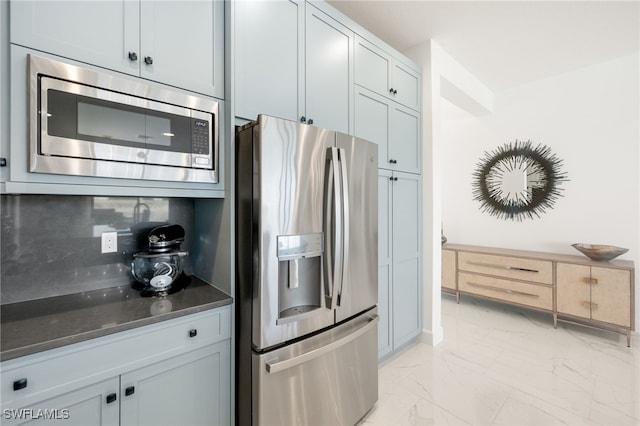 20321 Fair Oak Ln, Estero, FL 33928 - kitchen with stainless steel appliances, baseboards, marble finish floor, and backsplash