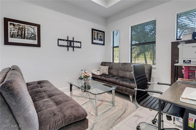 living room featuring plenty of natural light and baseboards