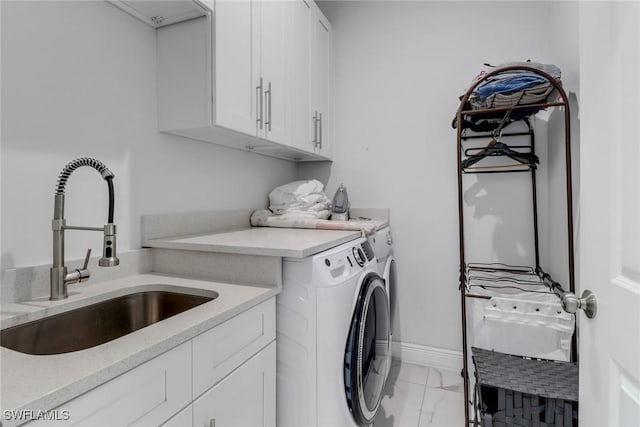 laundry room with a sink, separate washer and dryer, marble finish floor, cabinet space, and baseboards