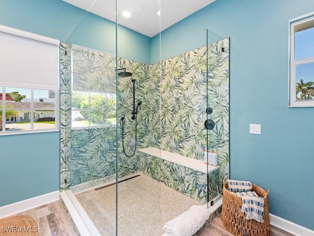 full bath featuring baseboards, walk in shower, and wood finished floors