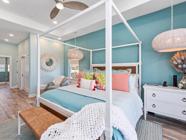 bedroom featuring baseboards, wood finished floors, and recessed lighting