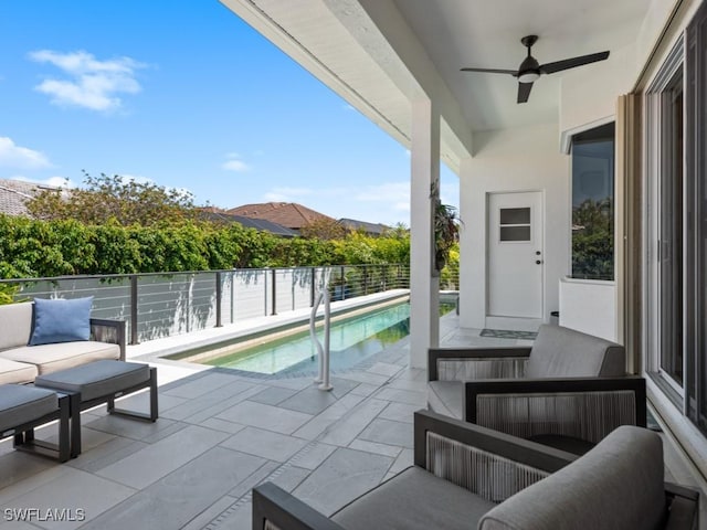 view of swimming pool featuring a fenced in pool, a patio area, ceiling fan, and an outdoor living space