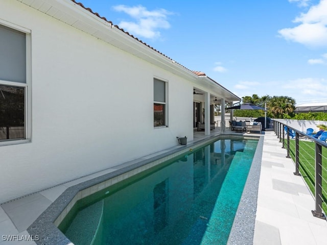 view of swimming pool featuring a patio area, a fenced in pool, and an outdoor hangout area