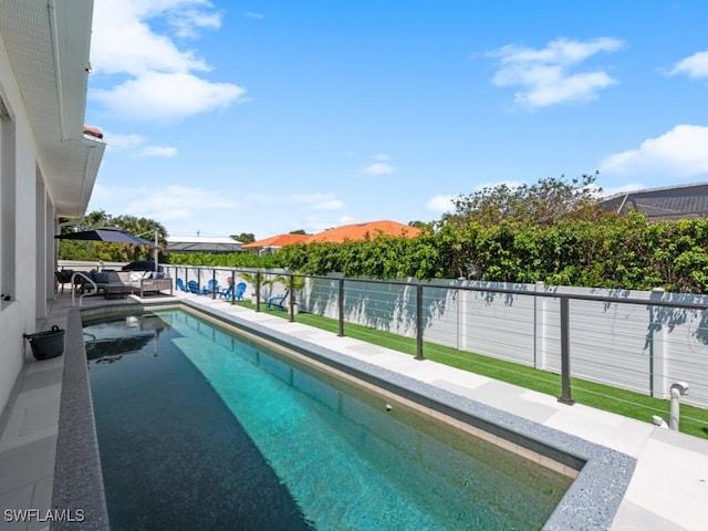 view of swimming pool with a fenced backyard and a fenced in pool