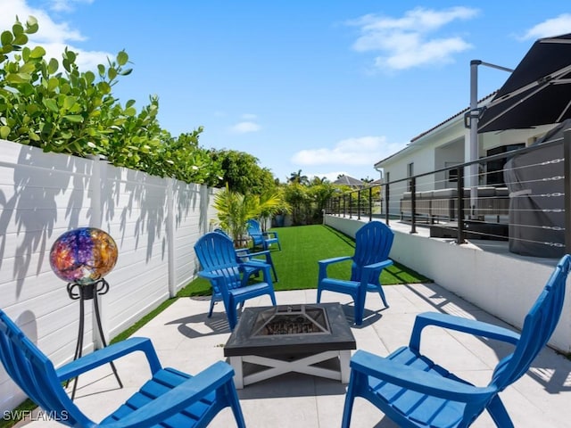 view of patio with a fenced backyard and an outdoor fire pit