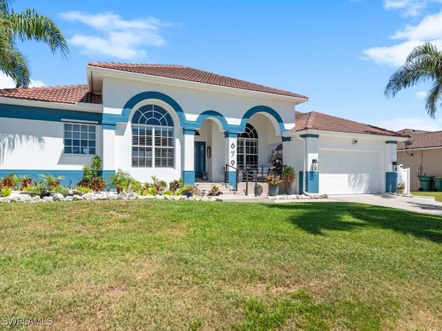 mediterranean / spanish-style home with stucco siding, a tile roof, a front yard, and a garage