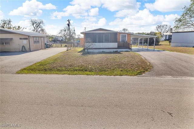264 Mamie St, Chokoloskee, FL 34138 - view of front of house featuring aphalt driveway and a sunroom