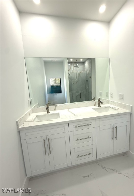 full bathroom with a sink, double vanity, and marble finish floor