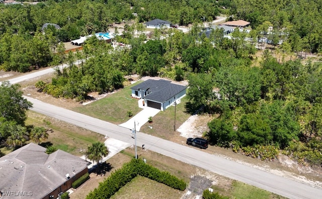 drone / aerial view with a wooded view
