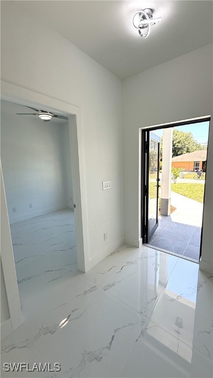 interior space featuring baseboards and marble finish floor