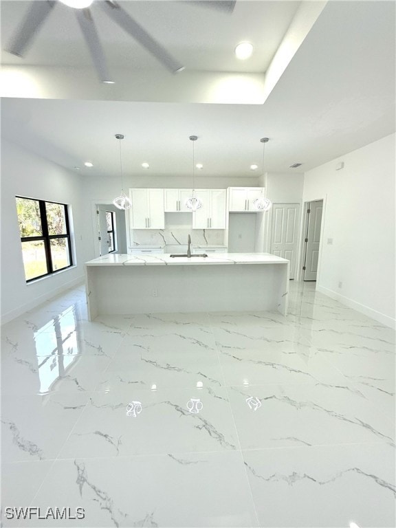 unfurnished living room with marble finish floor, baseboards, and recessed lighting