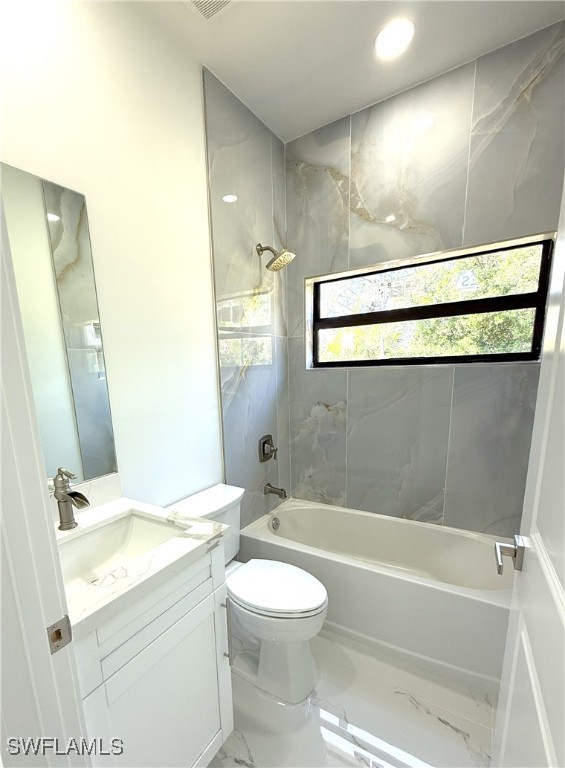 full bathroom featuring tub / shower combination, vanity, recessed lighting, toilet, and marble finish floor