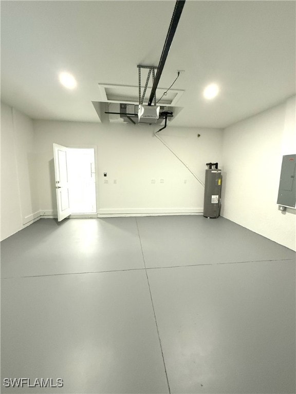 garage featuring recessed lighting, electric panel, and water heater