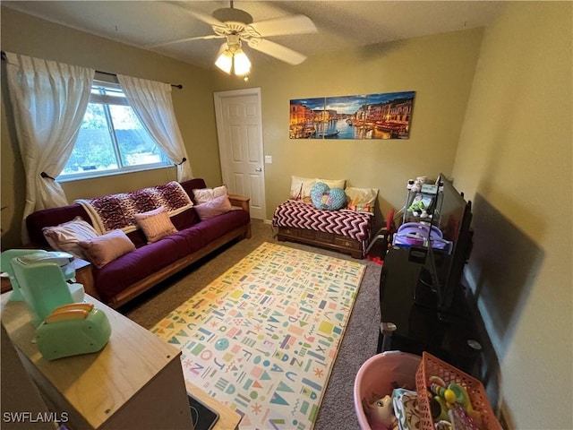 living area featuring ceiling fan and carpet floors