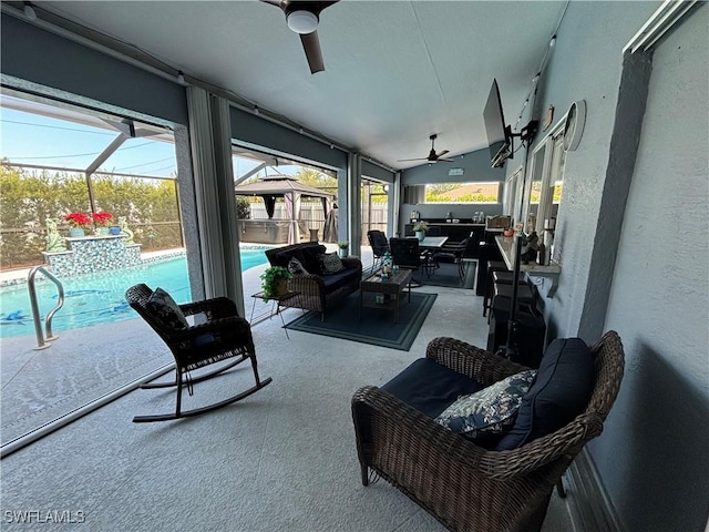 sunroom / solarium featuring outdoor dining area, an outdoor hangout area, a ceiling fan, and a healthy amount of sunlight