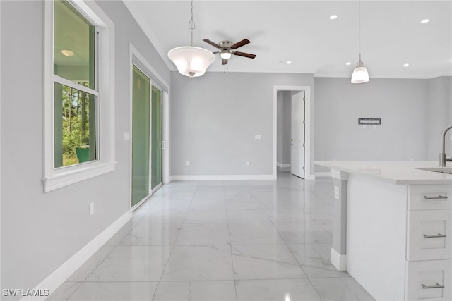 4140 31st Ave NE, Naples, FL 34120 - interior space featuring marble finish floor, baseboards, a ceiling fan, and a sink