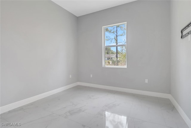 4140 31st Ave NE, Naples, FL 34120 - spare room with marble finish floor and baseboards