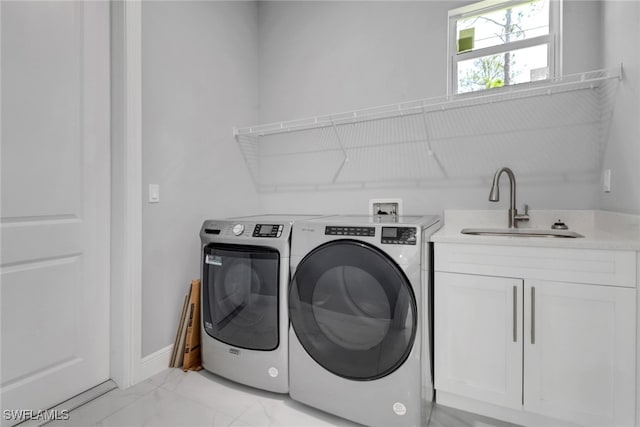 4140 31st Ave NE, Naples, FL 34120 - washroom featuring marble finish floor, a sink, washing machine and dryer, baseboards, and cabinet space