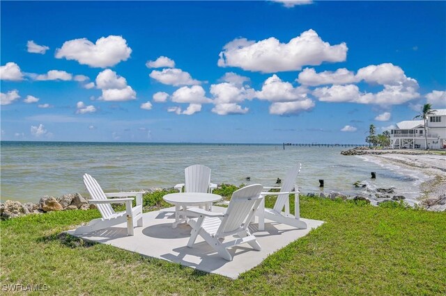 8241 Main St, Bokeelia, FL 33922 - view of grassy yard featuring a water view and a patio
