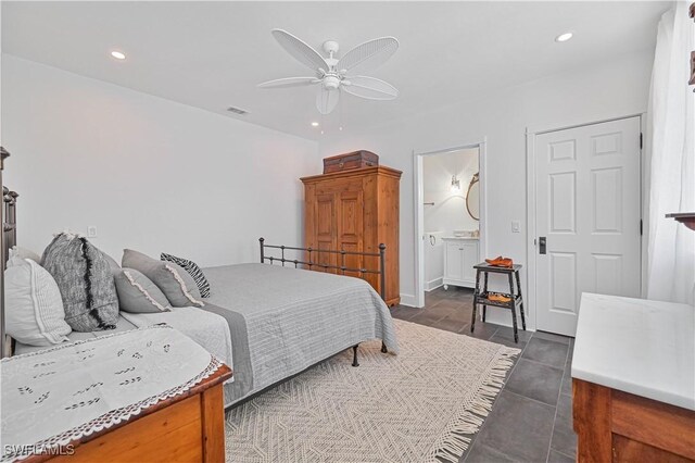 8241 Main St, Bokeelia, FL 33922 - bedroom with recessed lighting, ceiling fan, connected bathroom, and dark tile patterned flooring