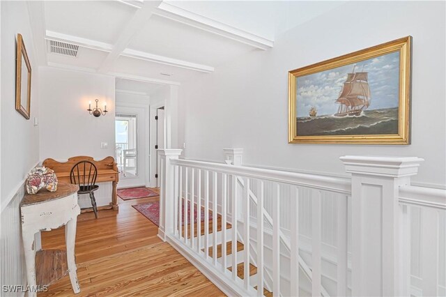 8241 Main St, Bokeelia, FL 33922 - corridor featuring light wood-type flooring, beam ceiling, coffered ceiling, and an upstairs landing