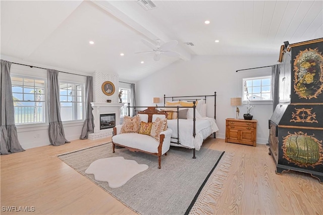 8241 Main St, Bokeelia, FL 33922 - bedroom featuring light wood-style flooring, a fireplace, a ceiling fan, recessed lighting, and baseboards