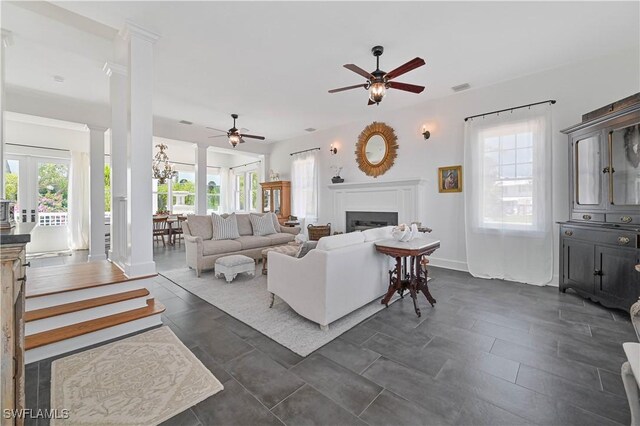 8241 Main St, Bokeelia, FL 33922 - living room featuring a ceiling fan, healthy amount of natural light, a fireplace, and baseboards