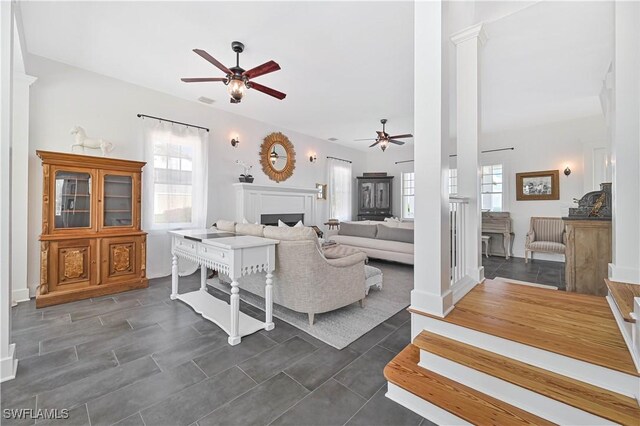 8241 Main St, Bokeelia, FL 33922 - living area featuring a ceiling fan, decorative columns, and plenty of natural light