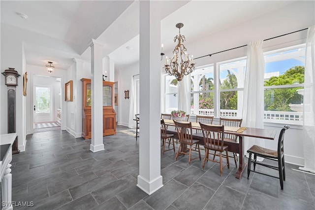 8241 Main St, Bokeelia, FL 33922 - dining area featuring a chandelier and baseboards
