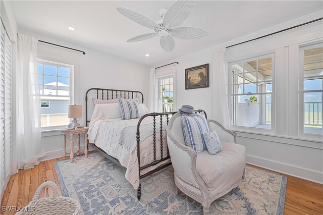 8241 Main St, Bokeelia, FL 33922 - bedroom featuring wood finished floors, a ceiling fan, baseboards, and recessed lighting