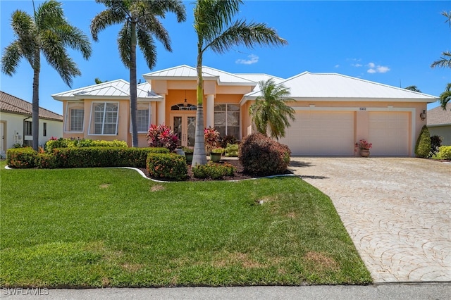 5302 SW 27th Pl, Cape Coral, FL 33914 - view of front of house featuring an attached garage, driveway, a front yard, and stucco siding
