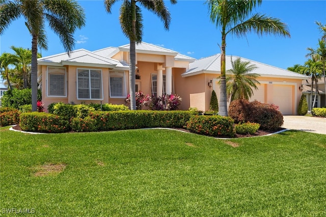 5302 SW 27th Pl, Cape Coral, FL 33914 - view of front of house with a garage, stucco siding, driveway, and a front yard