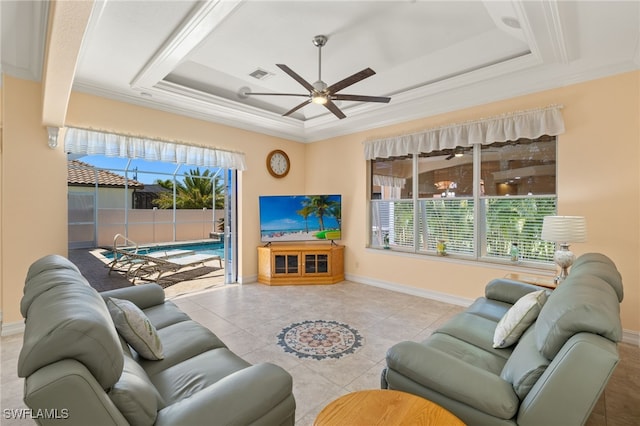 5302 SW 27th Pl, Cape Coral, FL 33914 - tiled living area featuring a raised ceiling, healthy amount of natural light, ceiling fan, baseboards, and ornamental molding