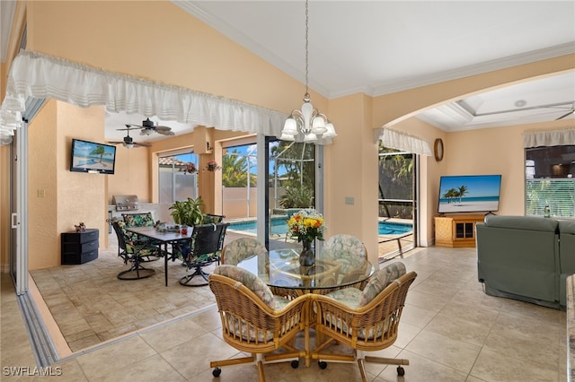 5302 SW 27th Pl, Cape Coral, FL 33914 - dining area featuring a ceiling fan, arched walkways, crown molding, a chandelier, and tile patterned flooring