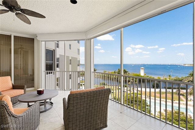 14270 Royal Harbour Ct Unit 620, Fort Myers, FL 33908 - sunroom / solarium with a water view, a ceiling fan, a textured ceiling, expansive windows, and tile patterned flooring