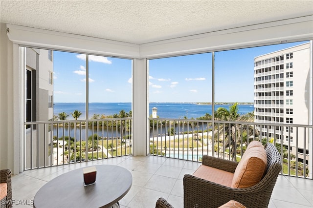 14270 Royal Harbour Ct Unit 620, Fort Myers, FL 33908 - sunroom / solarium featuring a water view, tile patterned flooring, healthy amount of natural light, and a textured ceiling
