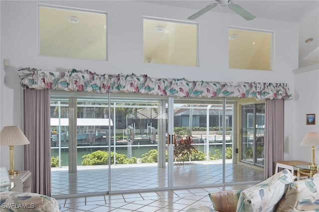 1181 Bond Ct, Marco Island, FL 34145 - doorway to outside with tile patterned flooring, a ceiling fan, and a water view